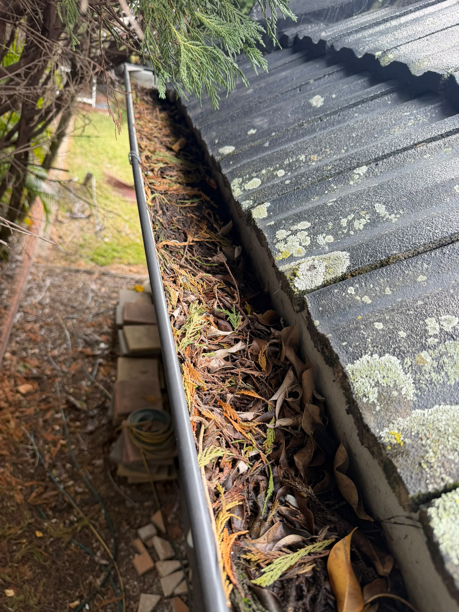Before gutter cleaning - Debris and silt removed, free-flowing again