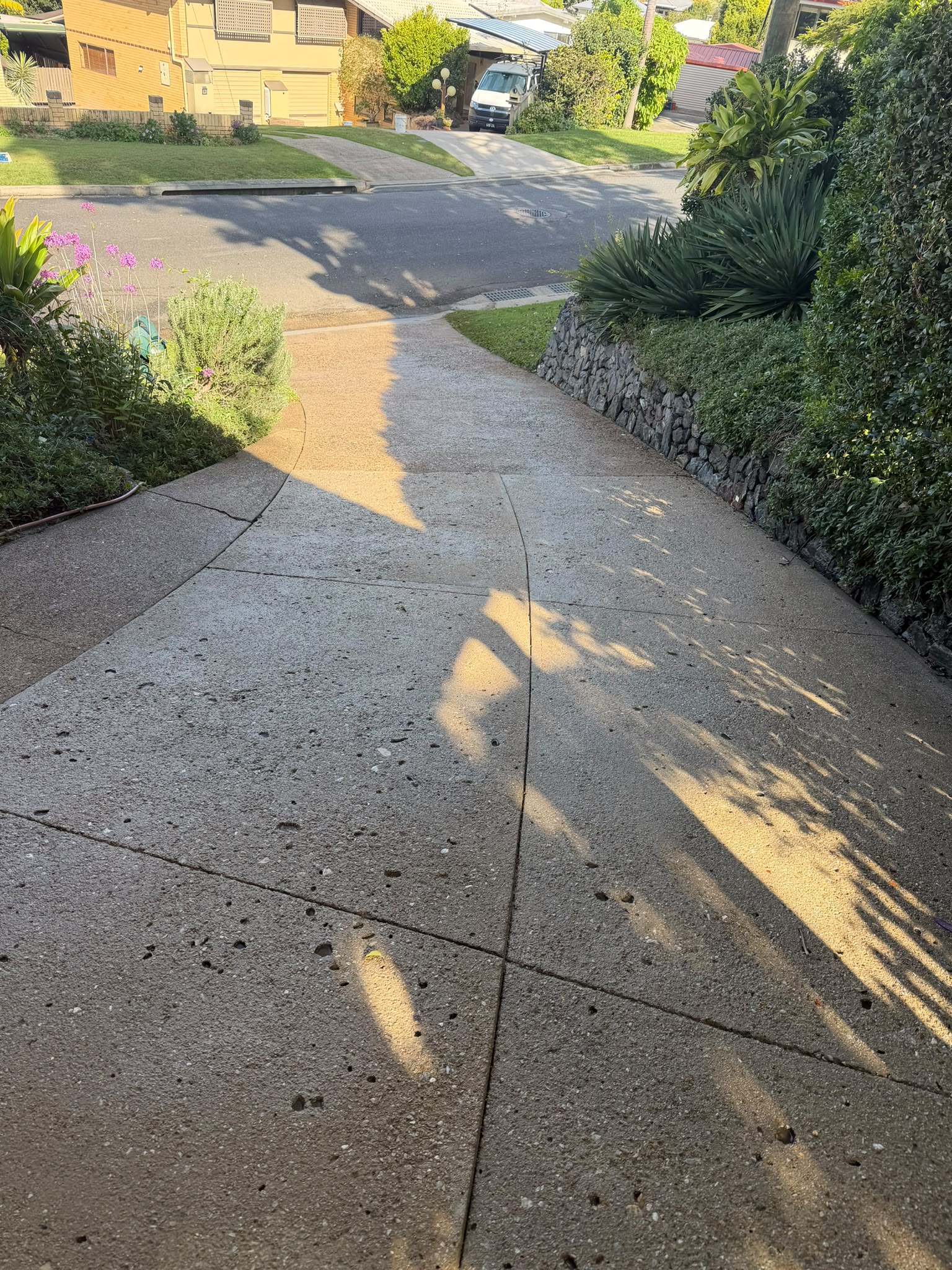 After driveways - Freshened hardstand area with a cleaner, brighter finish